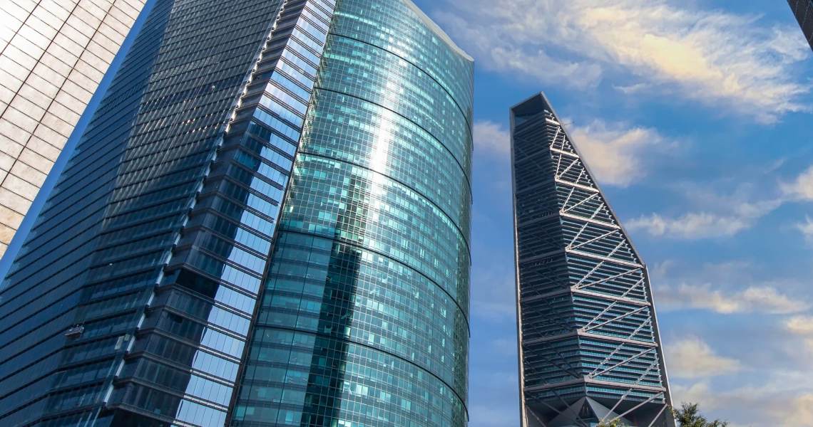 Close up sky scrappers against a blue sky