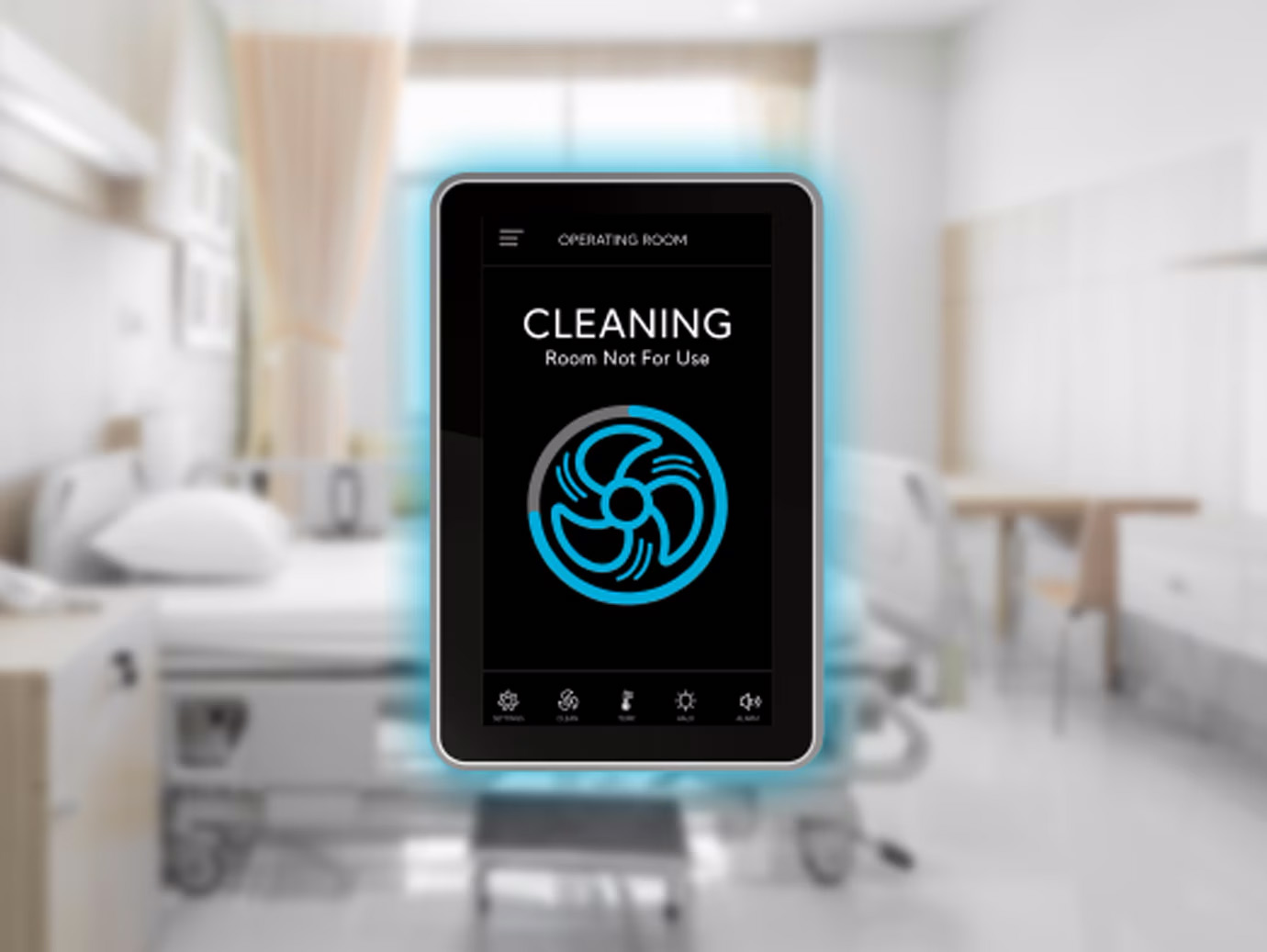 An FMS-2000 C monitor displaying a cleaning setting, overlaid over a hospital room