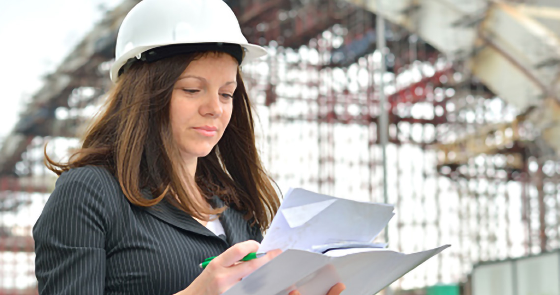 Farrell Boser, Project Manager at Johnson Controls, examining documents at a facility